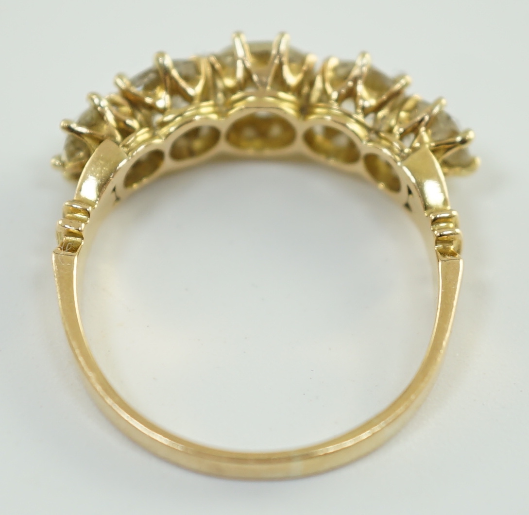 An 18ct gold and graduated five stone diamond set half hoop ring